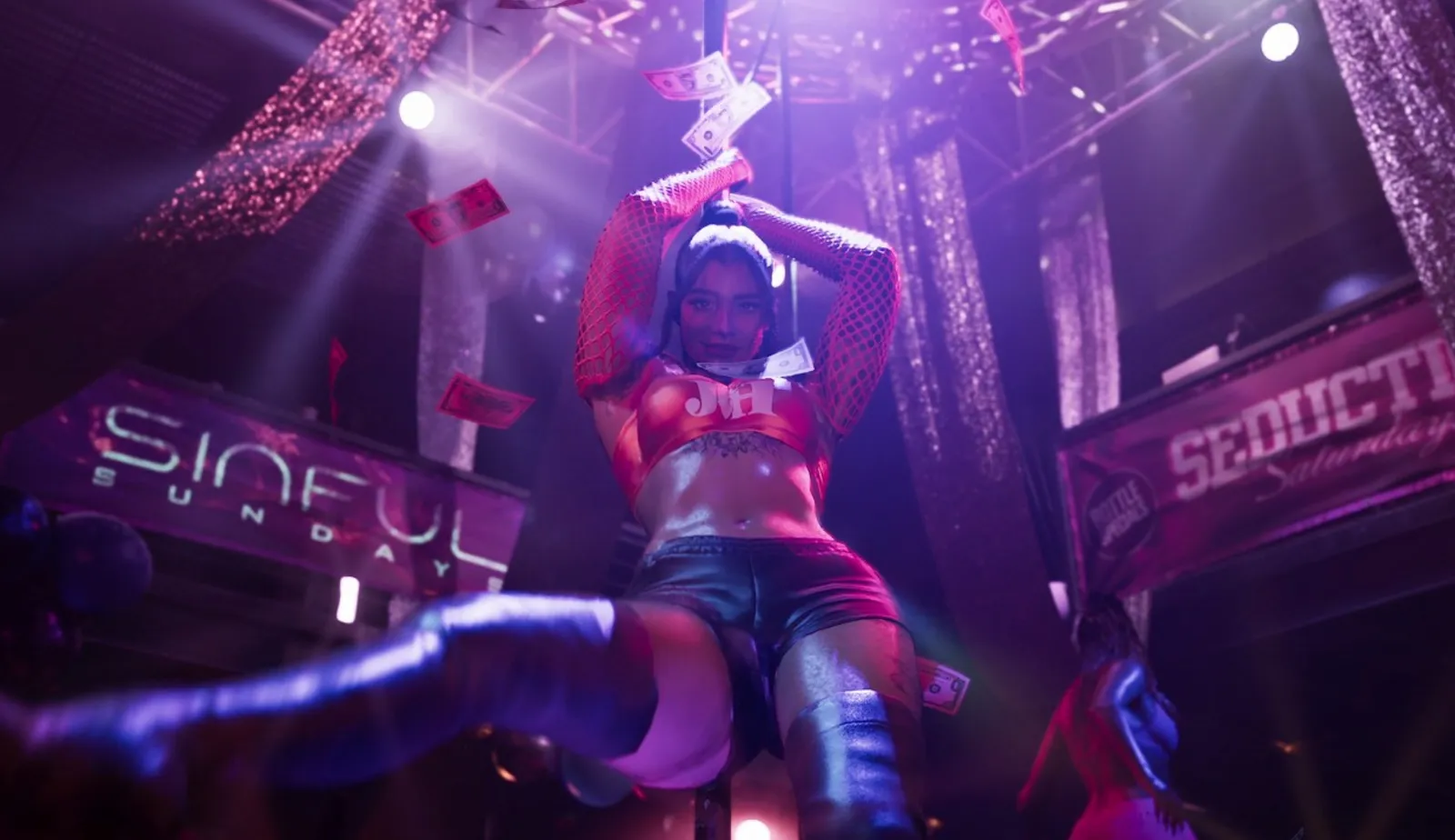 Dancer on stage under neon signs at a strip club in GTA 6.