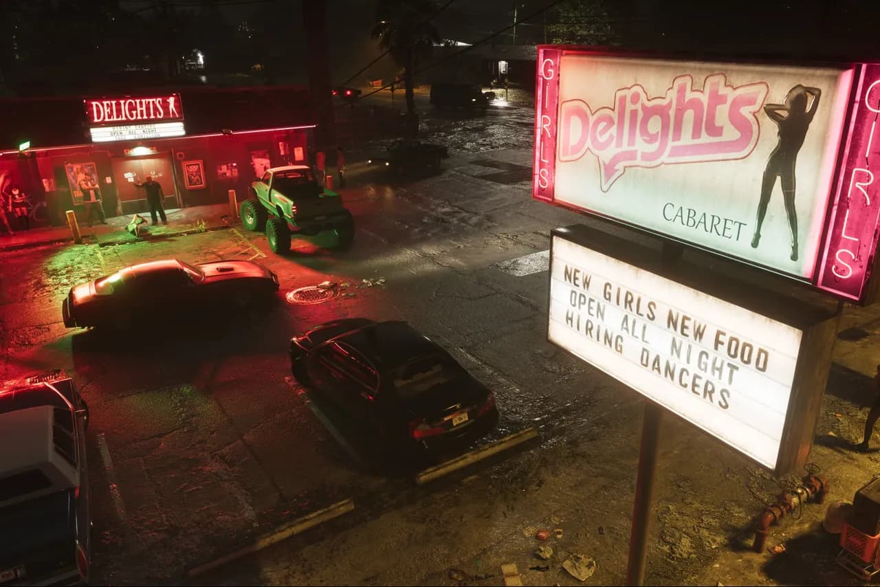 Delights Cabaret at night, its pink Girls-flanked roadside sign advertising new girls, new food and hiring dancers over a wet parking lot