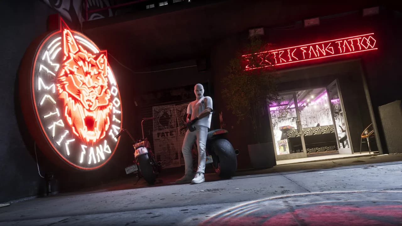 Electric Fang Tattoo storefront at night with its giant neon wolf-head sign