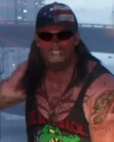 Bearded shirtless NPC in jorts walking along a Vice Beach sidewalk in Trailer 1.