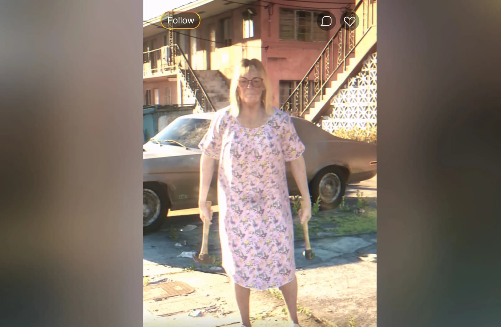 Middle-aged woman in a floral nightgown holding two hammers, mid-confrontation in a Hamlet driveway, framed inside a LuchaLibreFan livestream overlay.