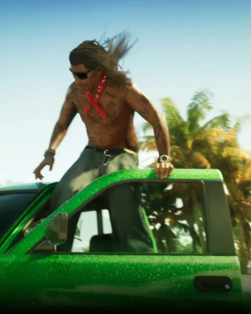 Rudi mid-stunt, climbing out of a green Bravado pickup truck on a Vice City road, long hair blowing in the wind, sunglasses, red bandana around his neck.