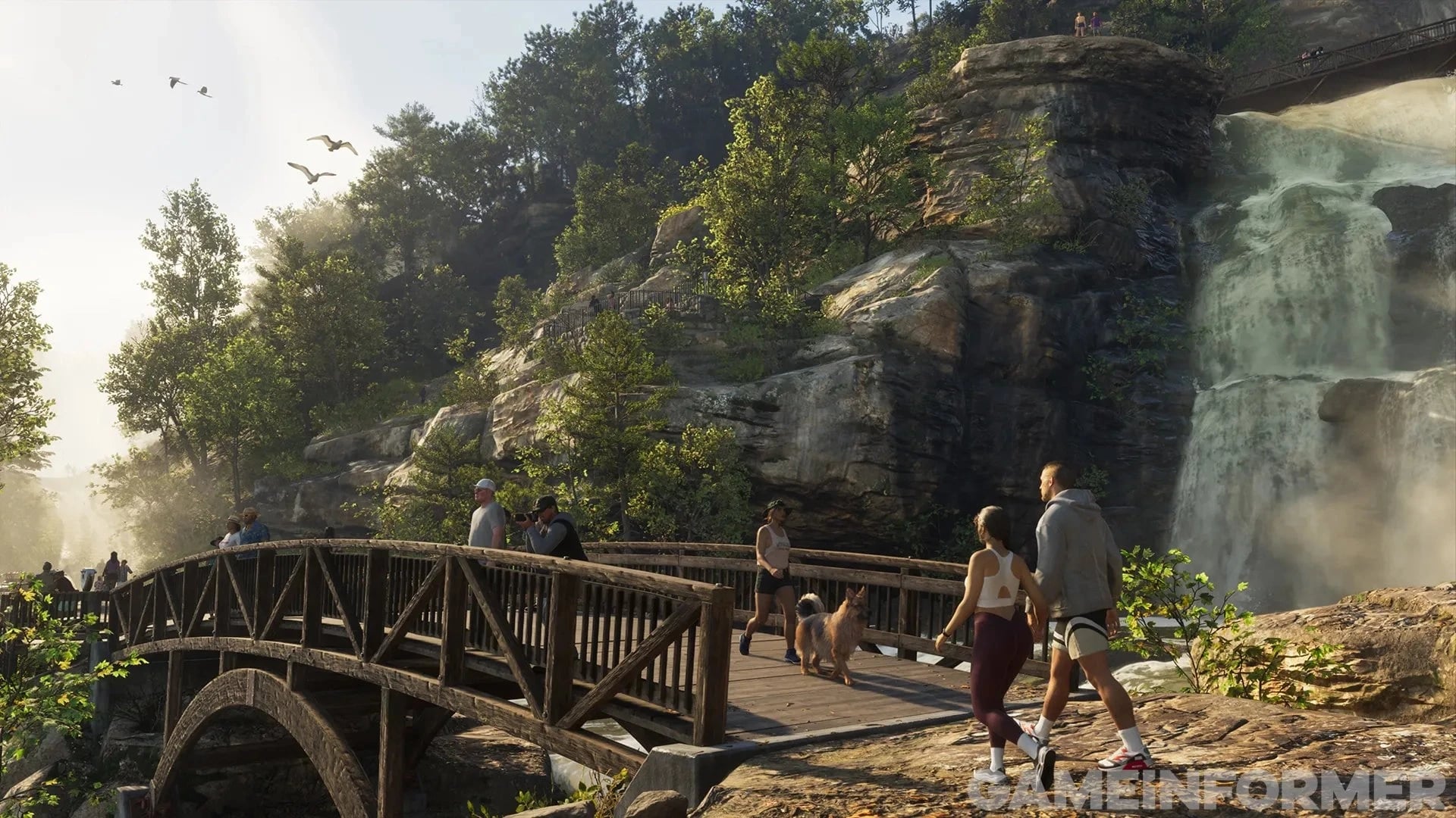 Hikers cross a waterfall bridge in Mount Kalaga National Park in GTA 6