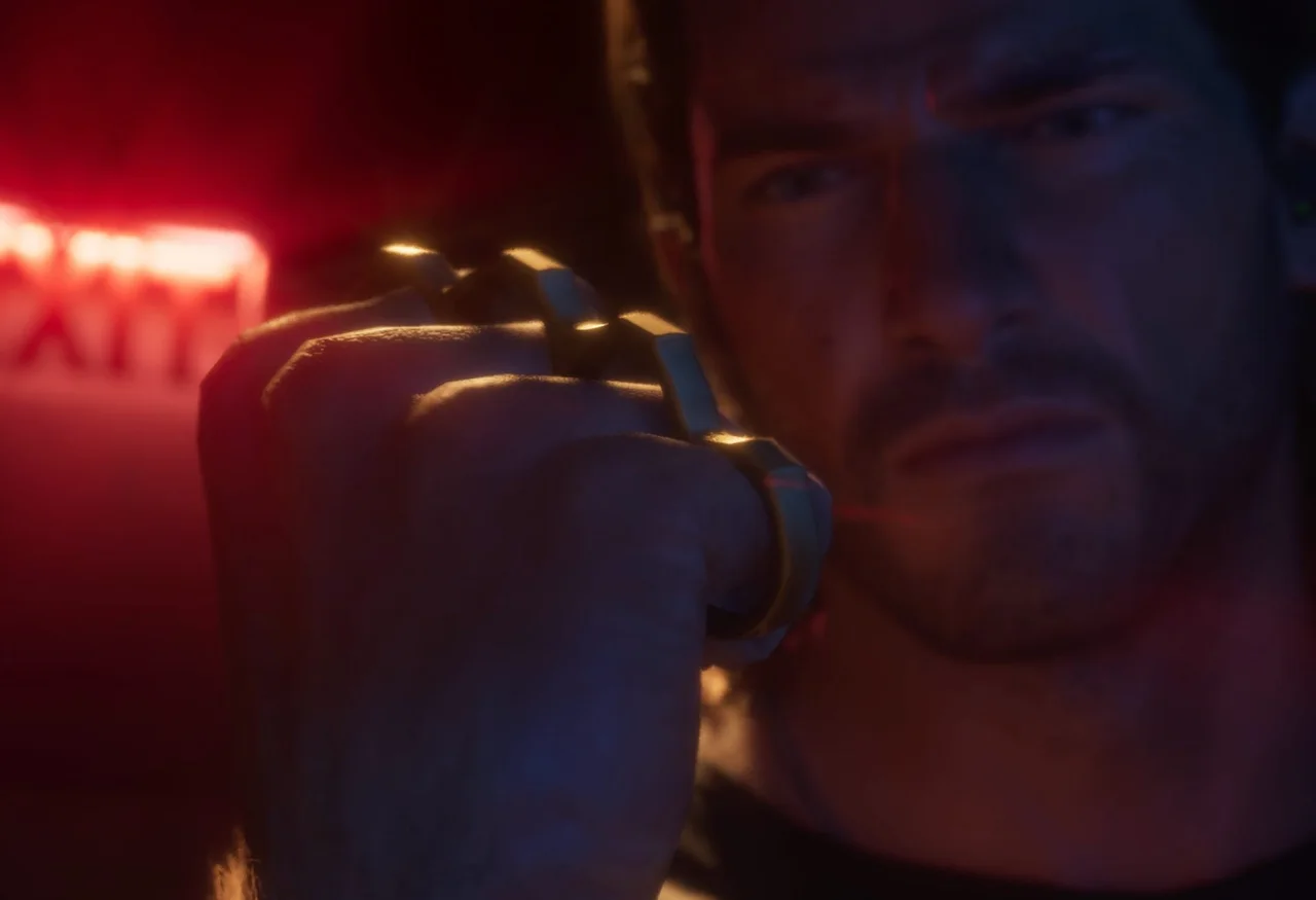 Close-up of a clenched fist wearing knuckle dusters in red neon light in GTA 6