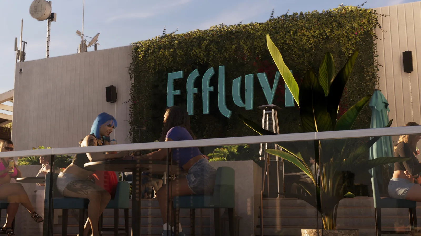 The Effluvia sign in teal letters above diners on the greenery wall of the terrace