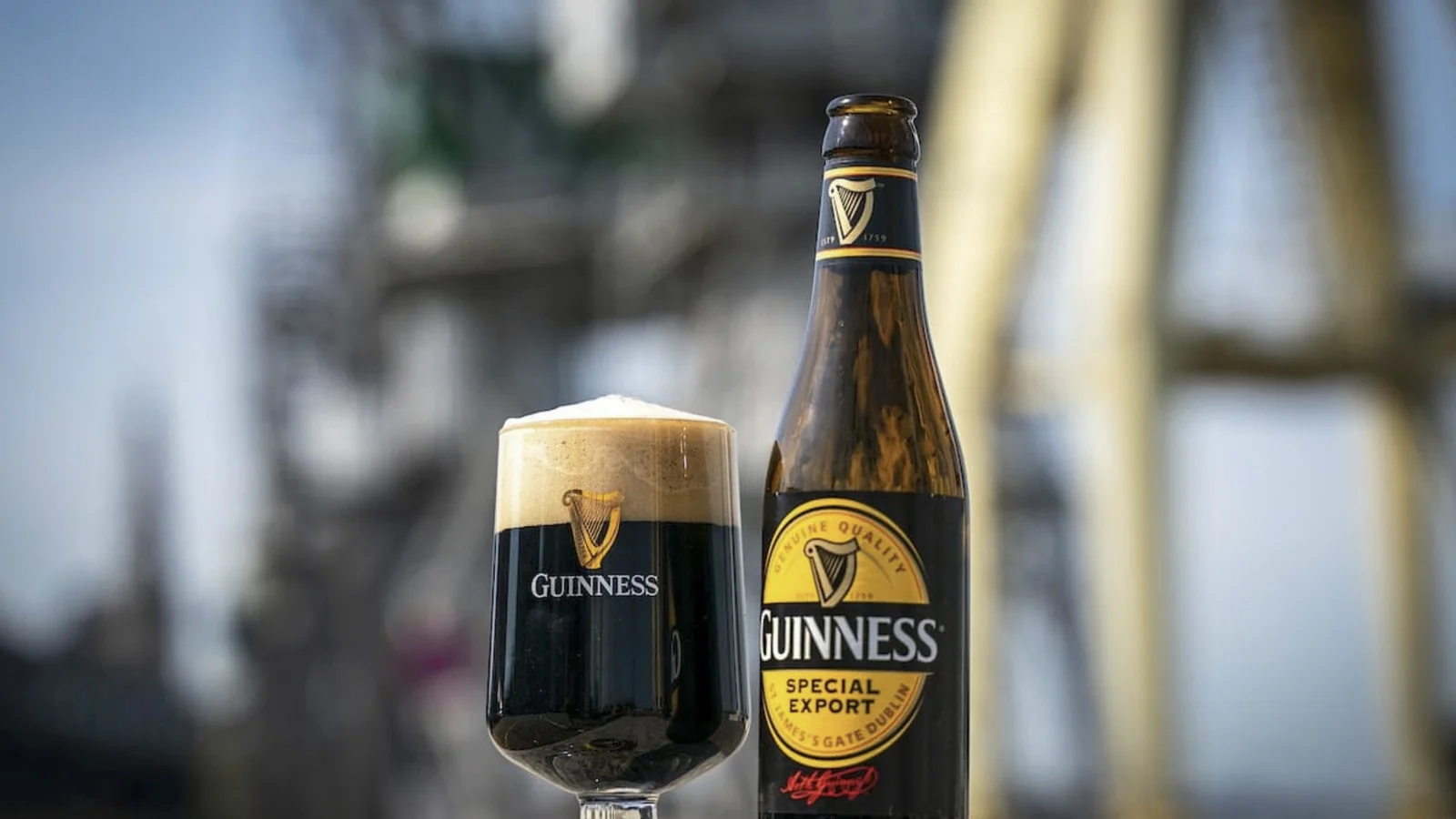 A pint and bottle of Guinness stout at a dockside