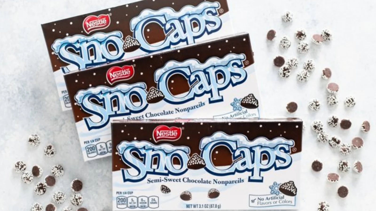 Sno-Caps candy boxes with scattered nonpareils