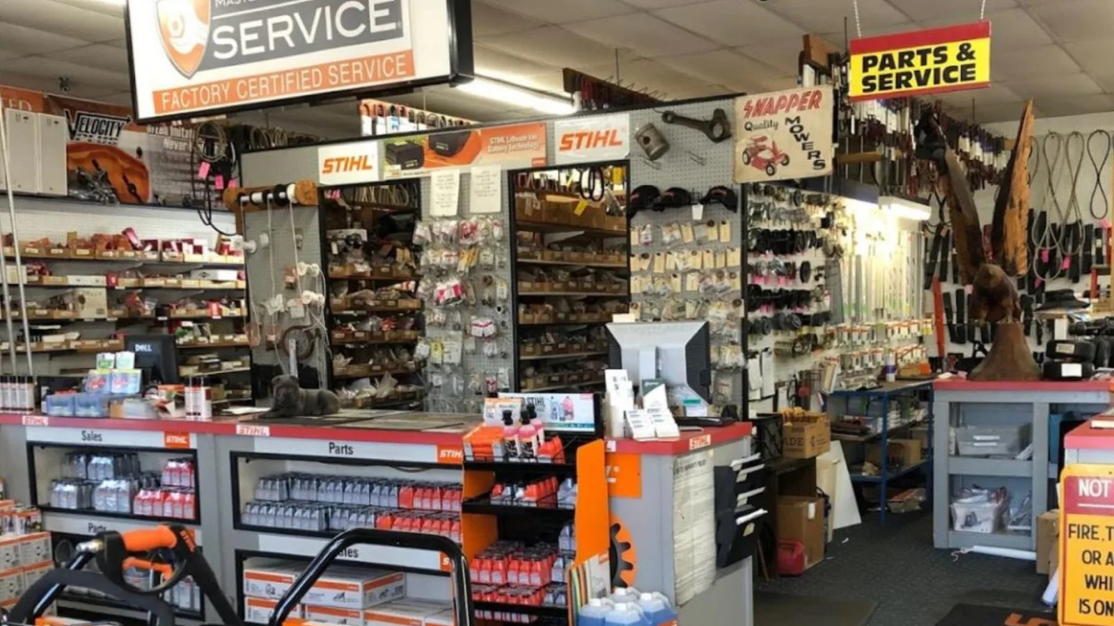Crowded aisles and the service counter of a tool shop