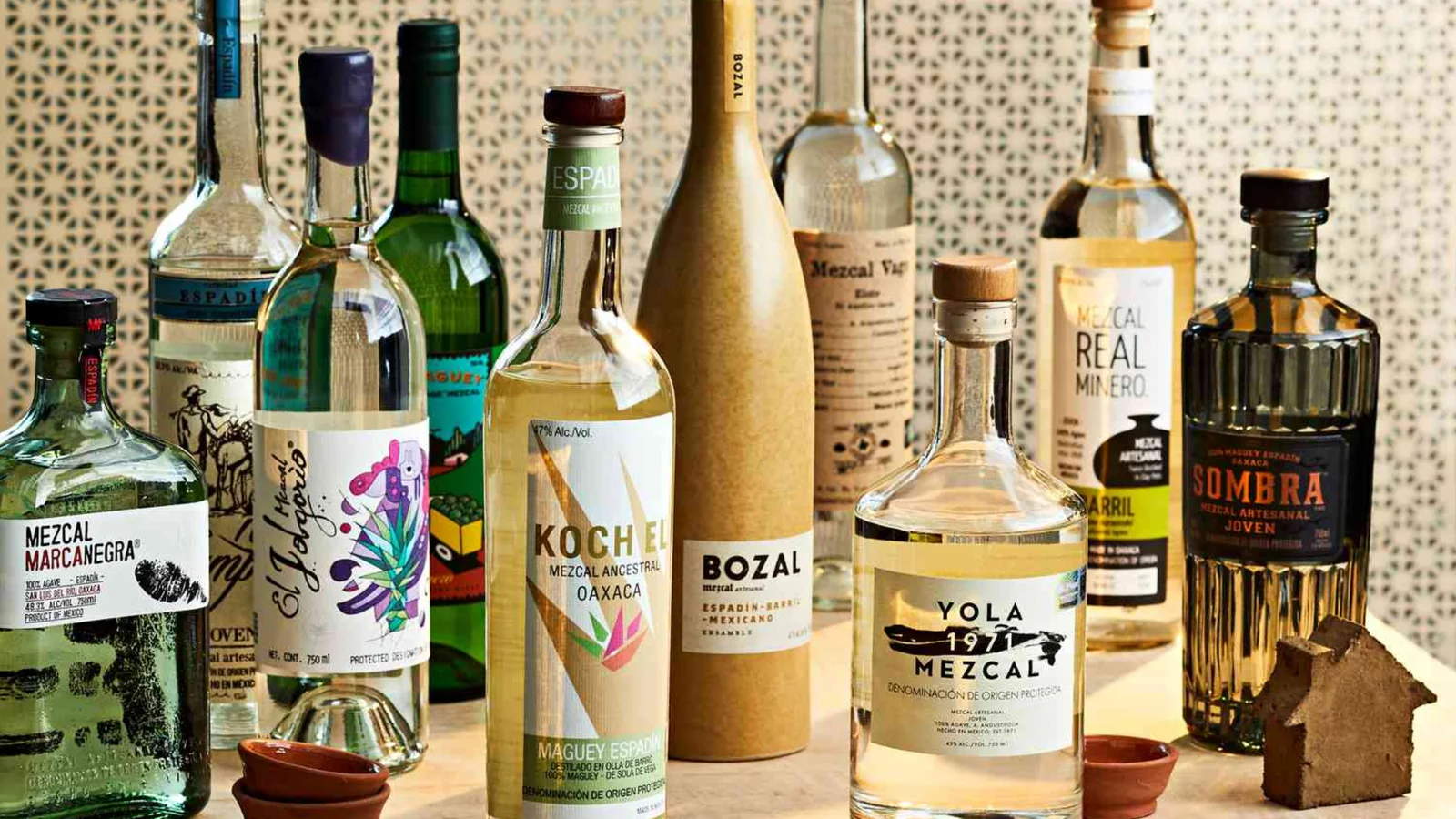 A line-up of artisanal mezcal bottles on a bar