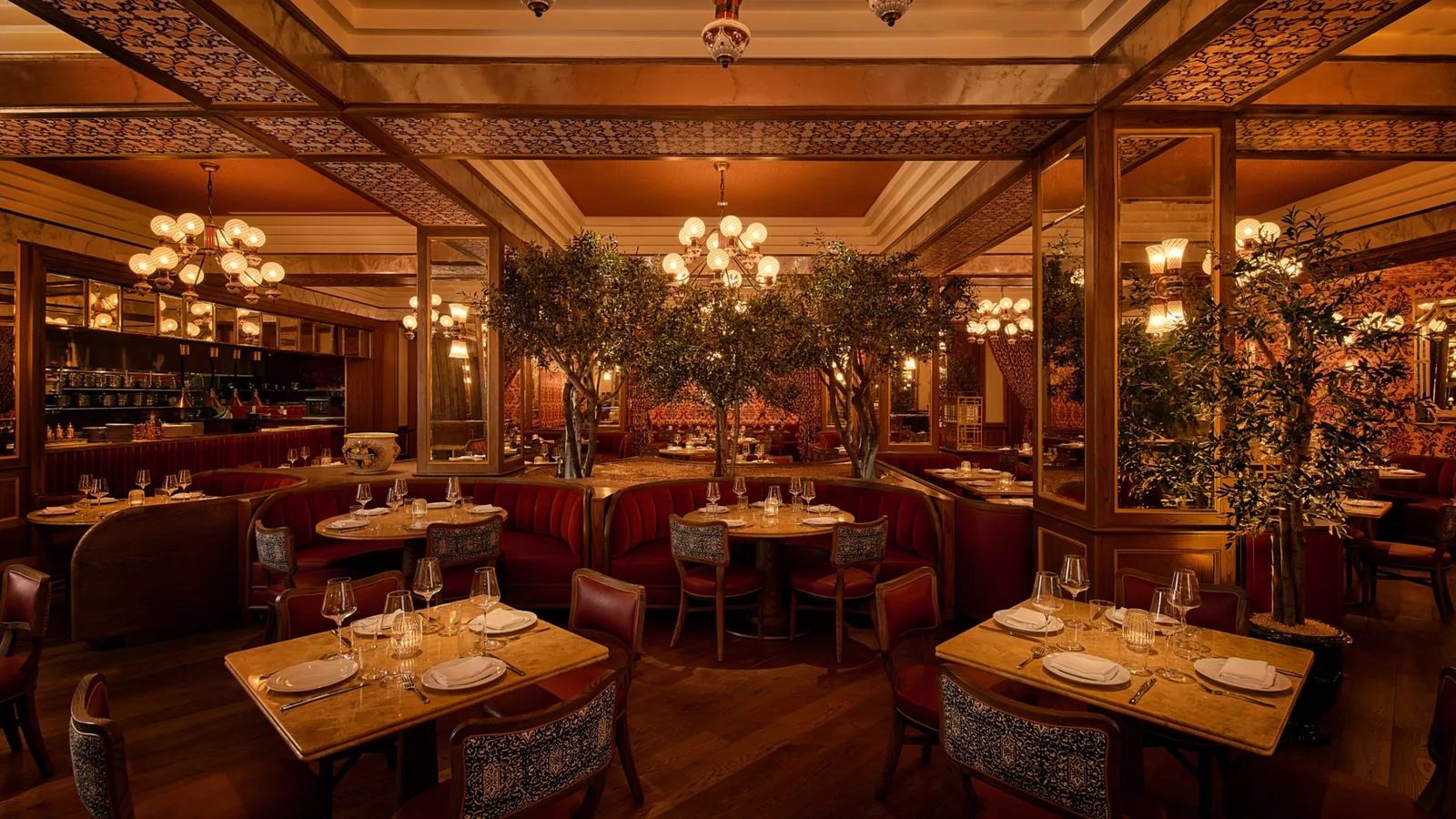 A warmly lit Italian dining room with white tablecloths