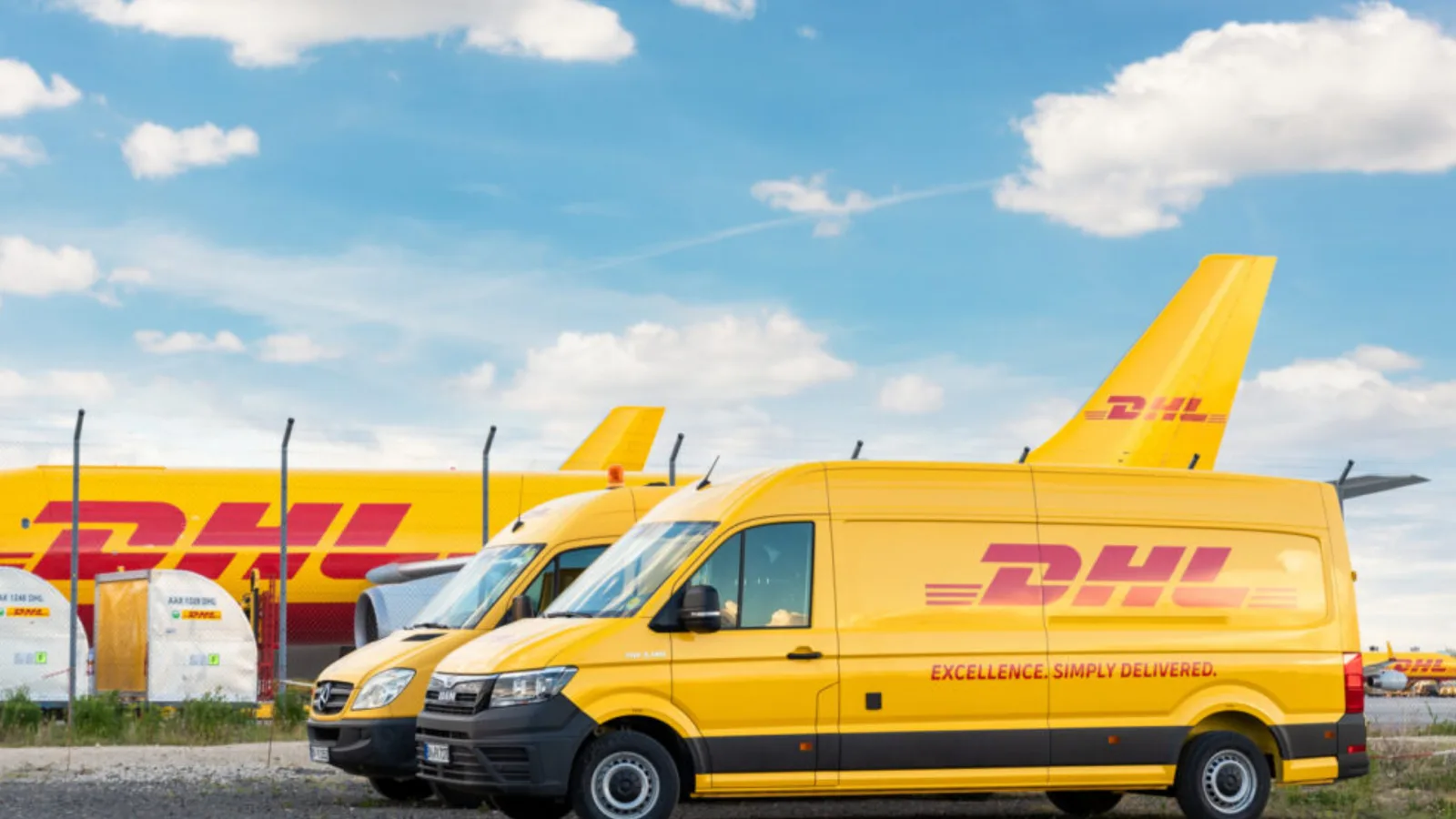 Yellow courier vans lined up outside a parcel depot