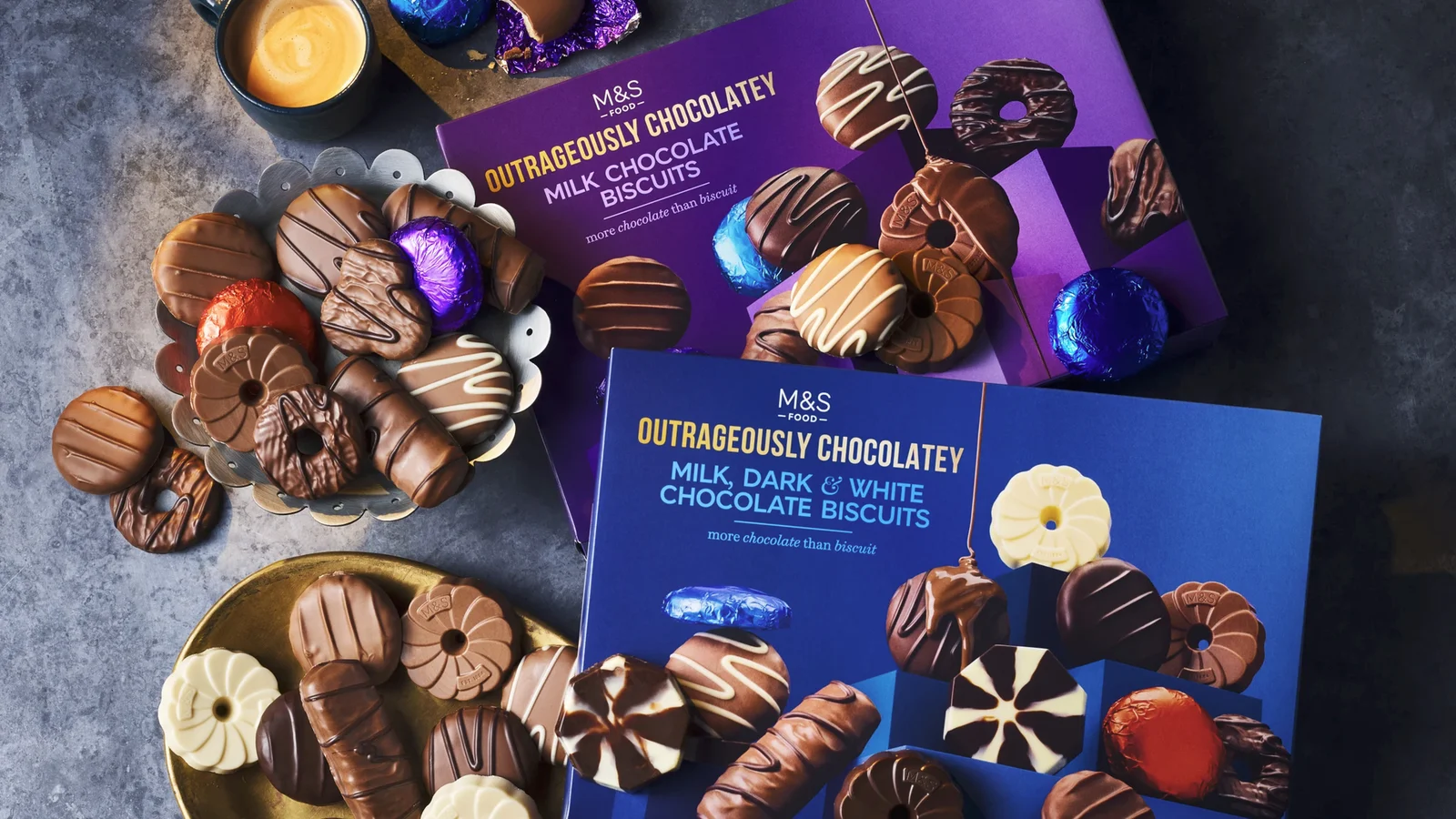 Boxes of chocolate biscuits arranged on a dark table