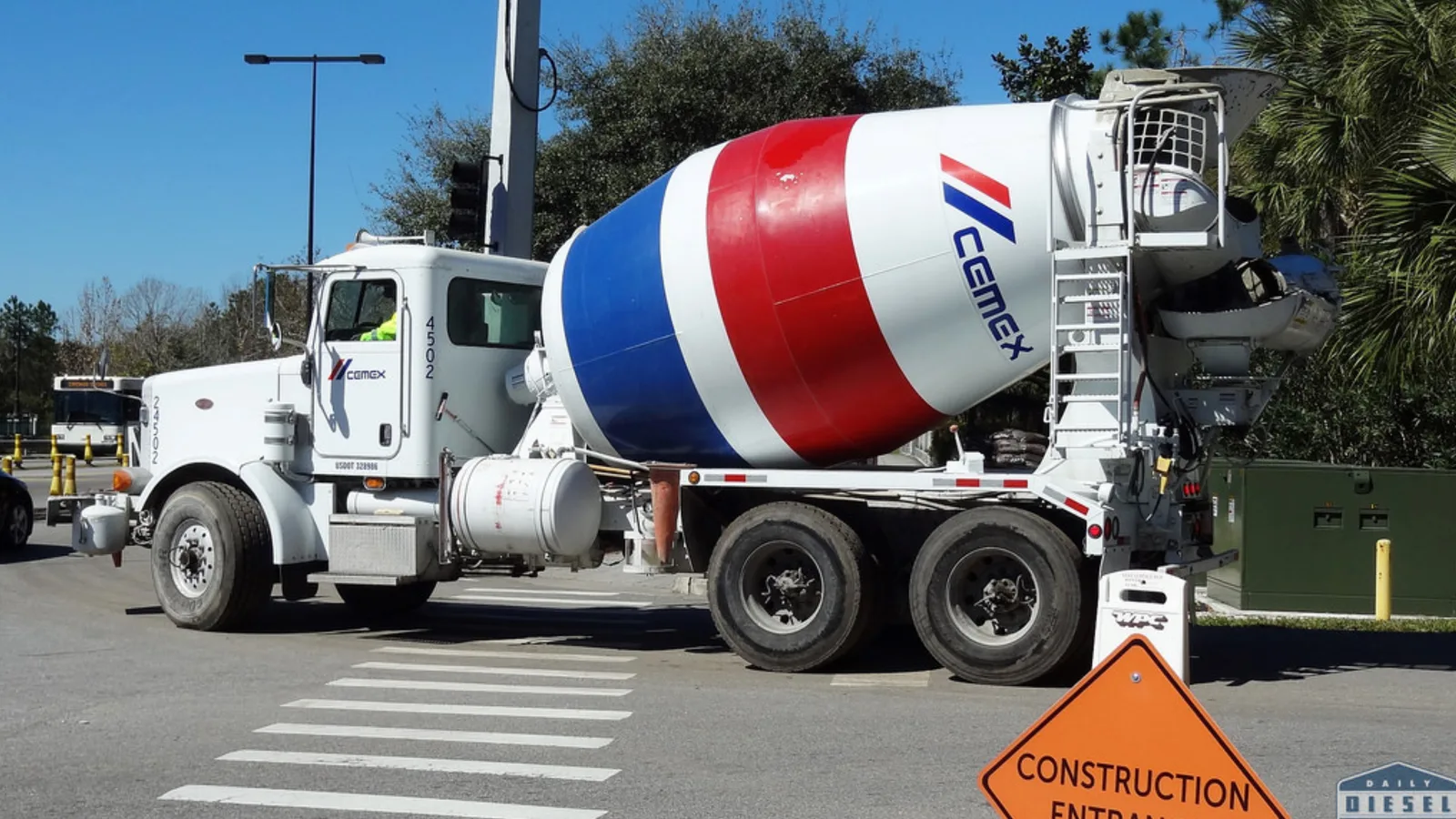 A cement mixer truck passing through a construction zone