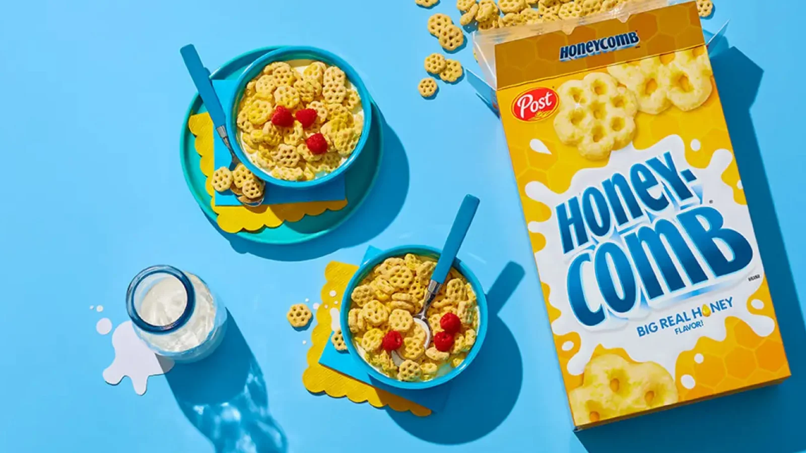 A box of Honeycomb cereal with filled bowls
