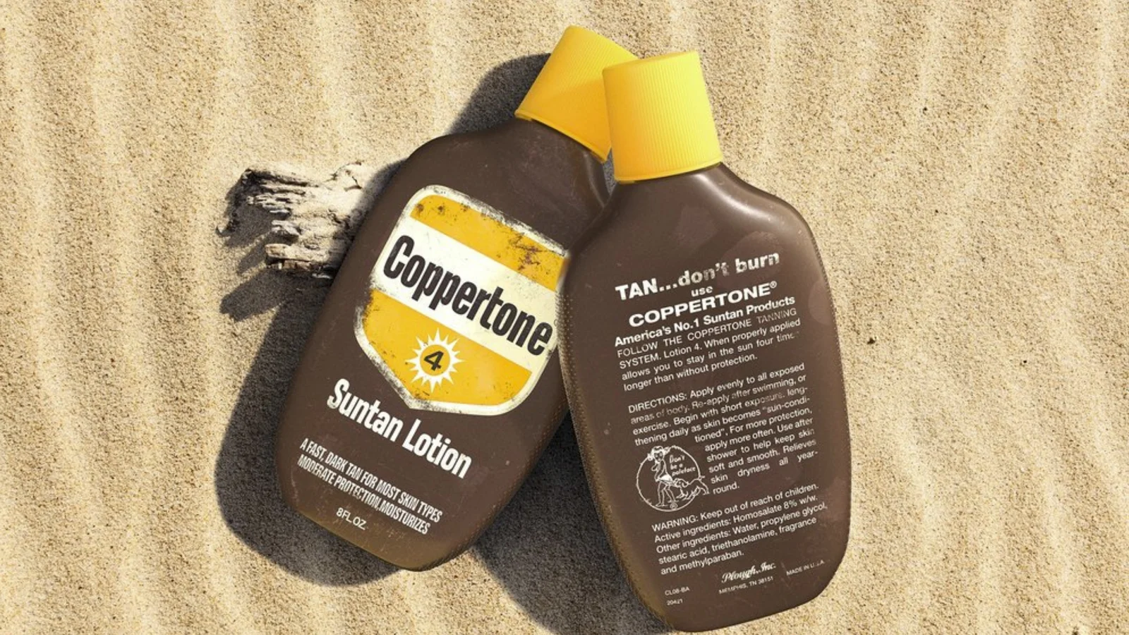 Vintage Coppertone suntan lotion bottles lying on beach sand