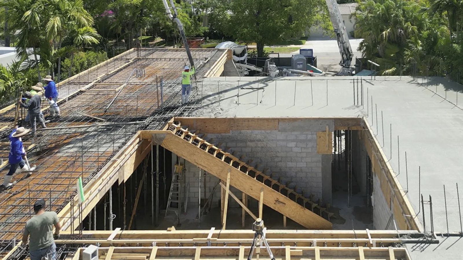 Workers setting foundation formwork on a construction site