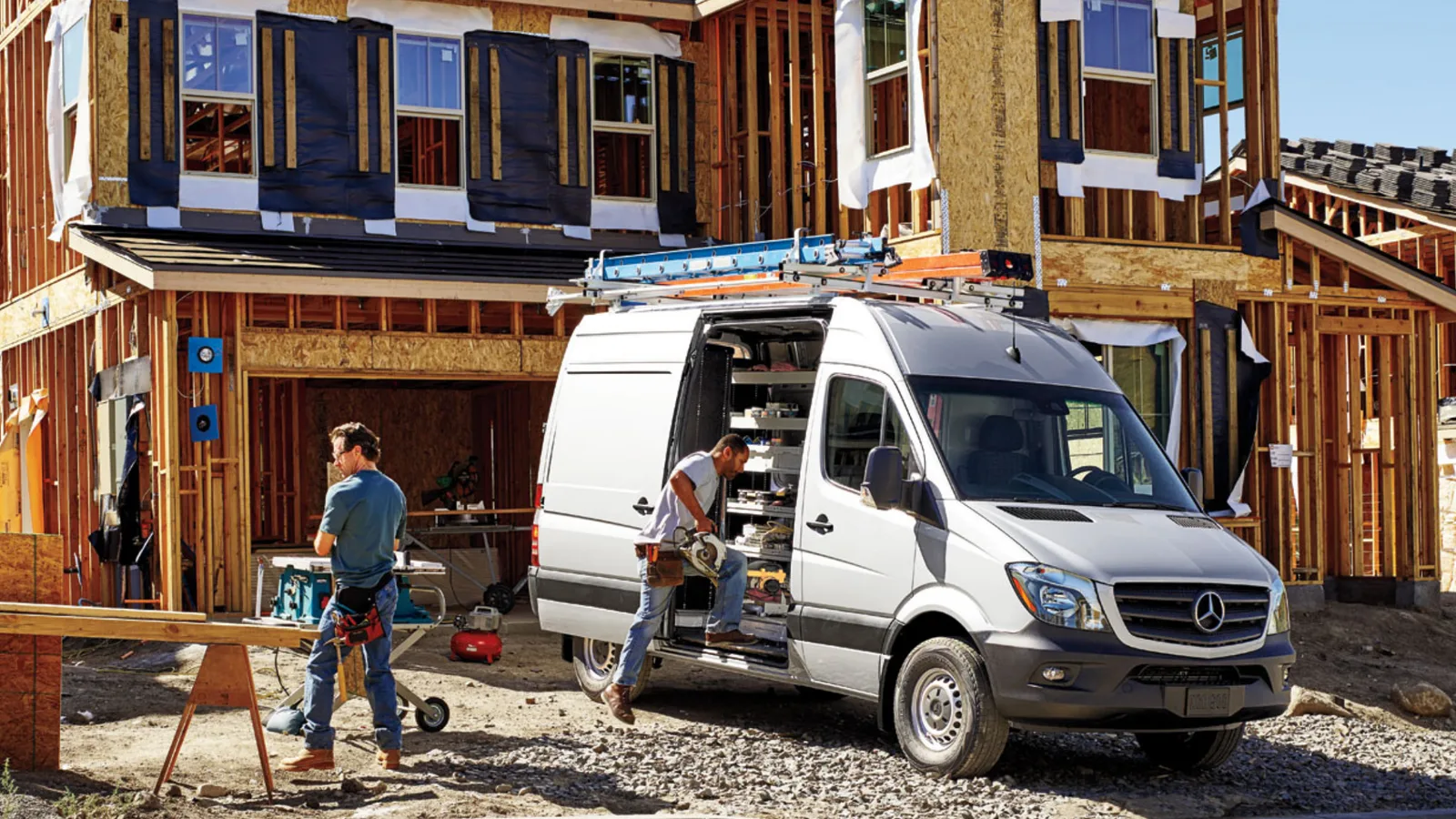 A contractor’s van parked at a timber framed house build