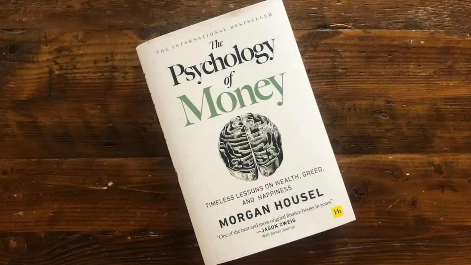 A personal finance paperback lying on a wooden table