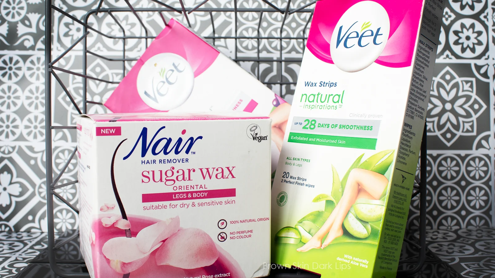 Veet wax strips and Nair sugar wax boxes in a wire basket