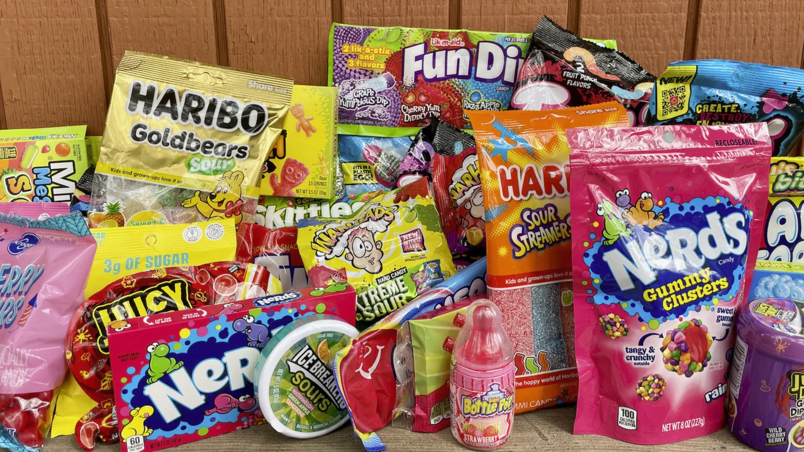A pile of sour candy bags and packets