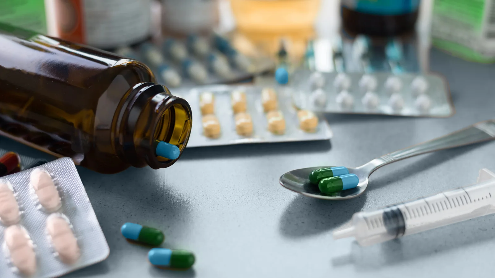 Cold and flu remedies with blister packs and a spoonful of capsules