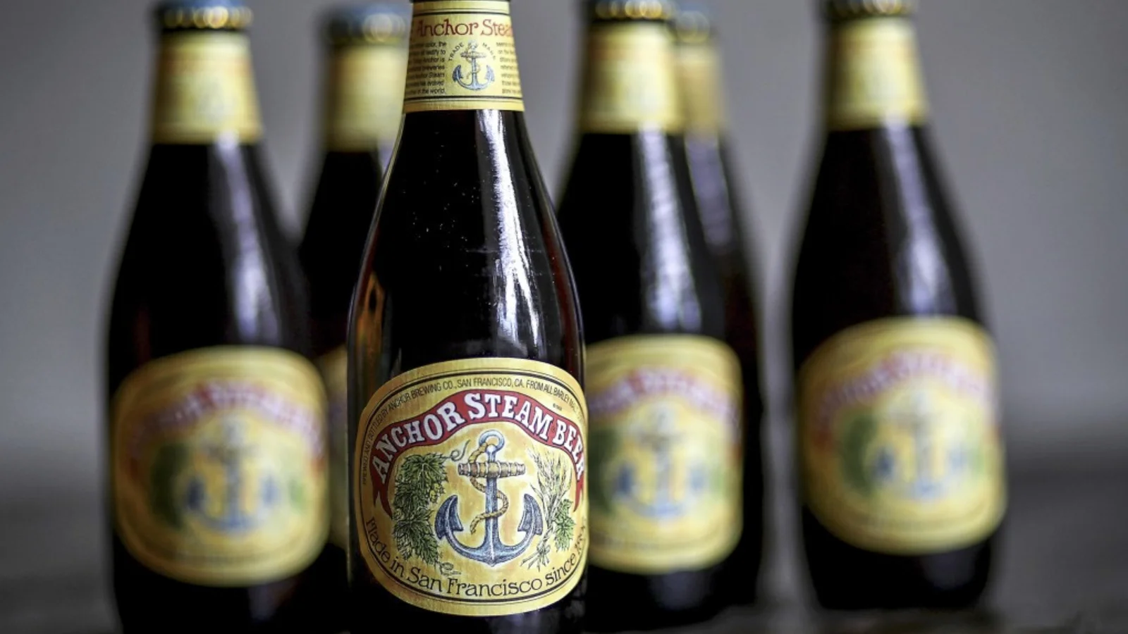 Anchor Steam beer bottles standing in a group