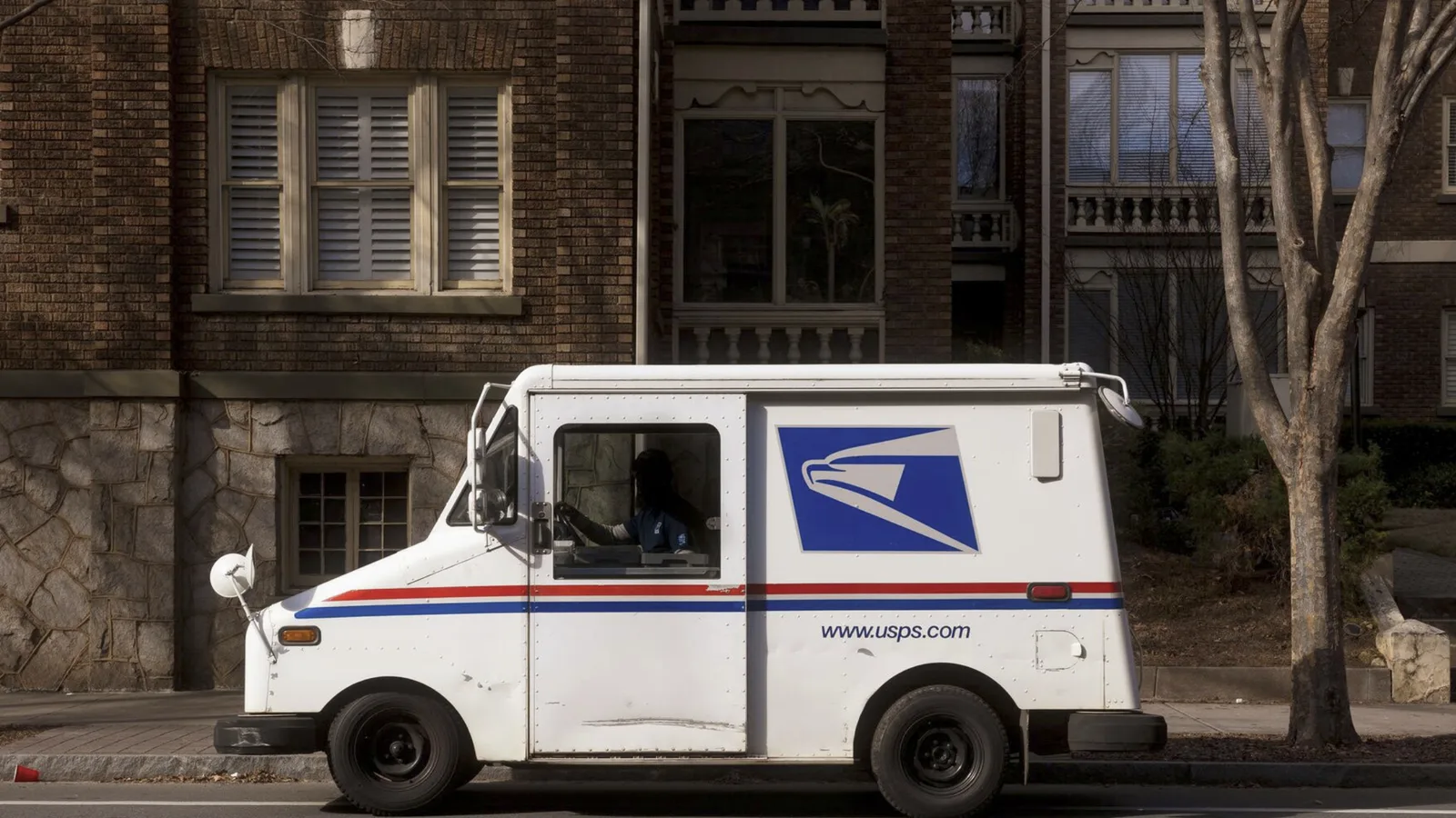 A classic American mail delivery van parked kerbside