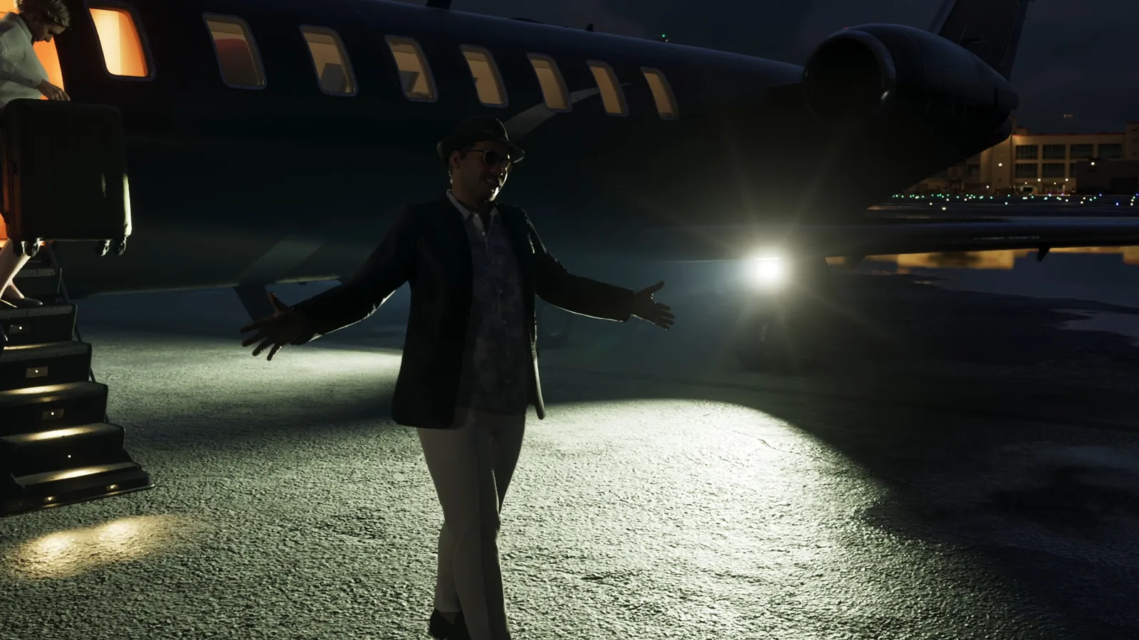 Andres de Leon spreads his arms in front of a private jet at night in GTA 6.