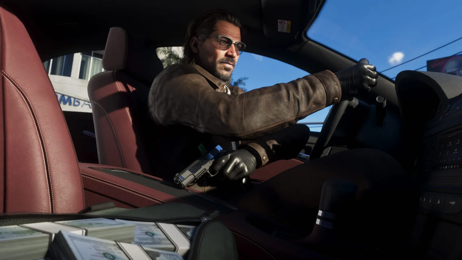 Raul Bautista driving with a pistol in one gloved hand and stacks of banded cash on the passenger seat in an official GTA 6 screenshot