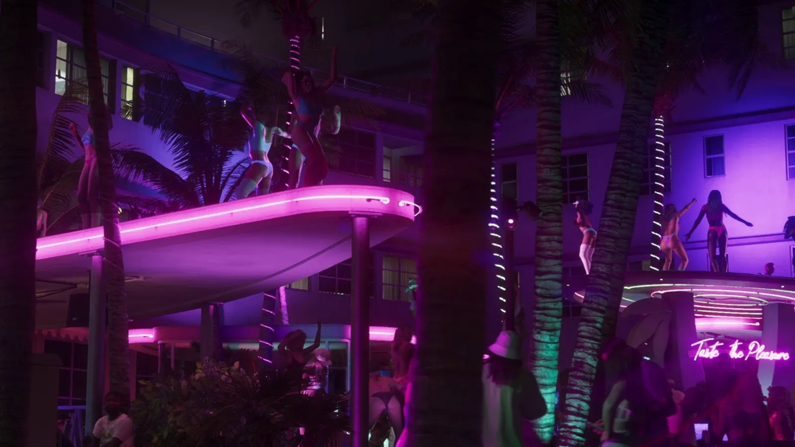 Neon-lit hotel pool deck with dancers on elevated platforms under palm trees at night in Vice City