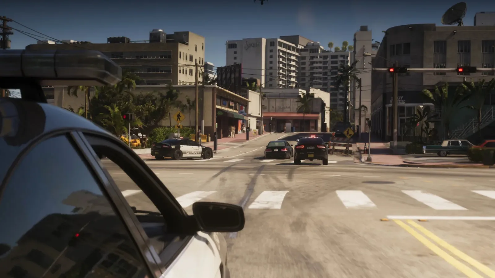 Police cars pulling over a sedan at a sunlit Vice City intersection seen from behind a parked car in GTA 6
