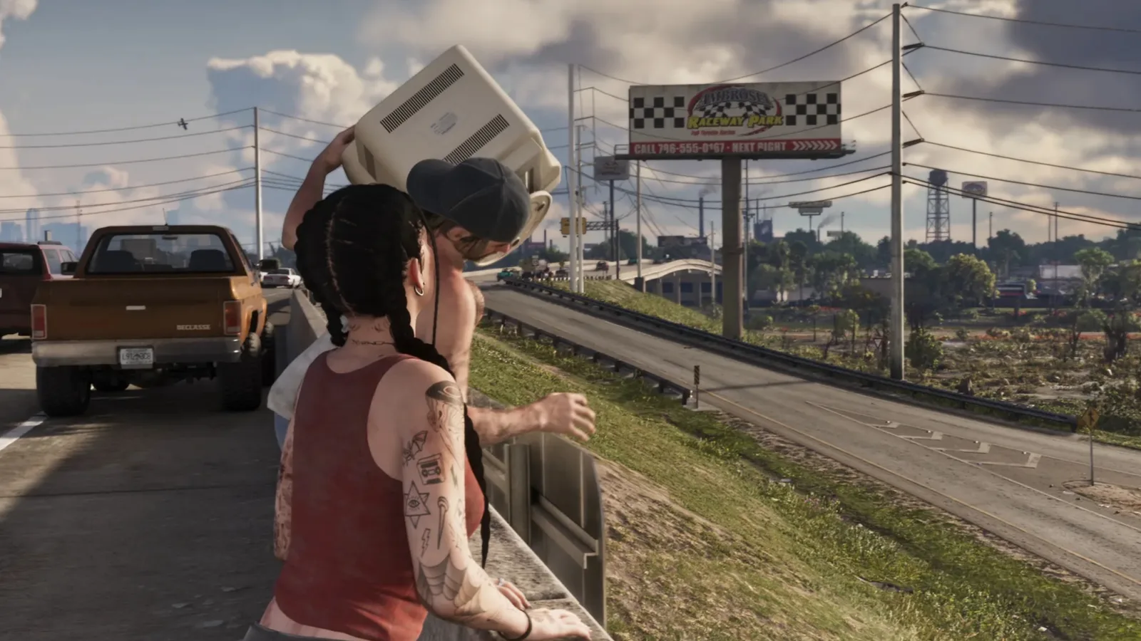 Jason lifting an old television over his head beside Lucia on a freeway overpass in GTA 6