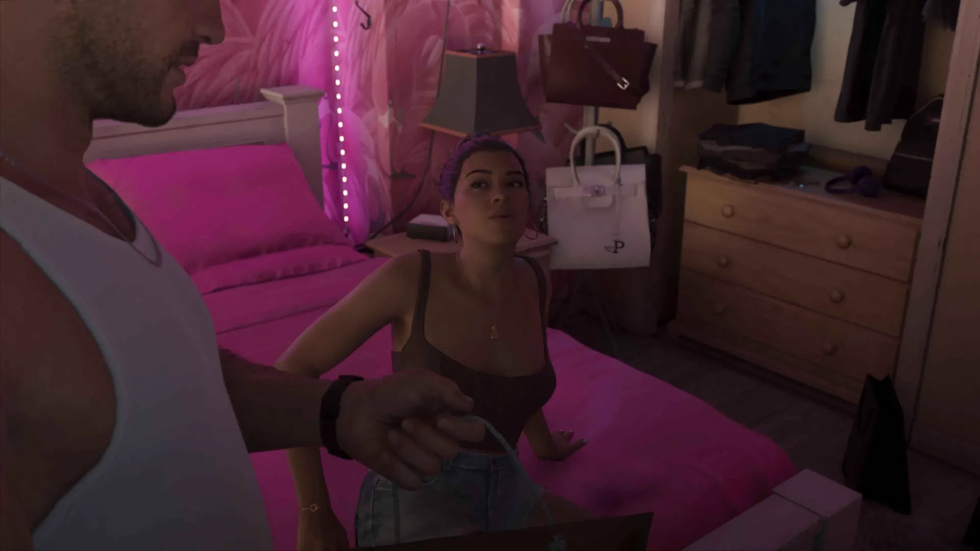 Lucia sitting on the bed of the pink safehouse room while Jason stands beside her in the GTA 6 Extended Look