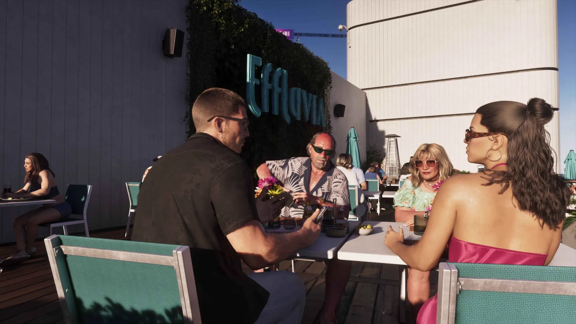 Jason and Lucia sit at an outdoor table with an older couple beneath the Effluvia sign at a sunlit GTA 6 rooftop bar