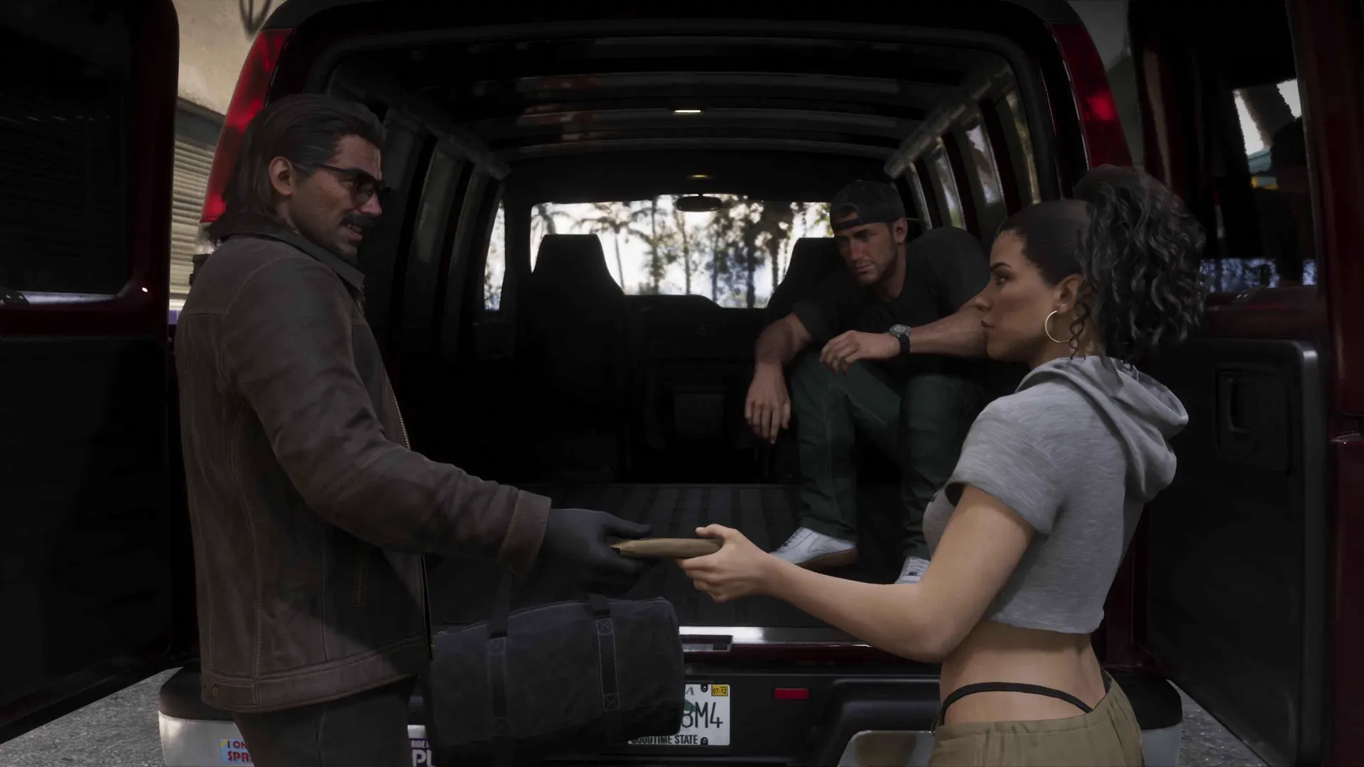 A long-haired man in a leather jacket hands an item to Lucia over a duffel bag at the open rear doors of a maroon van in GTA 6 while a younger man in a backwards cap sits inside
