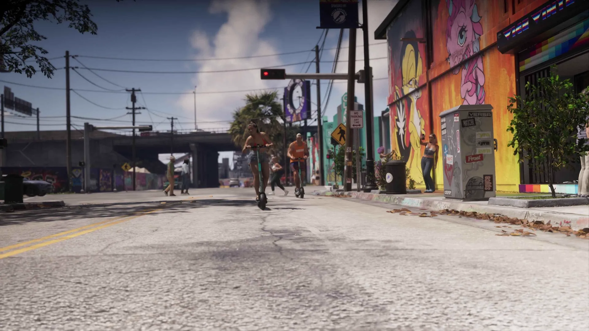 Two GTA 6 NPCs riding electric scooters down a sunlit street lined with graffiti murals while a woman takes a phone photo against a painted wall near an underpass