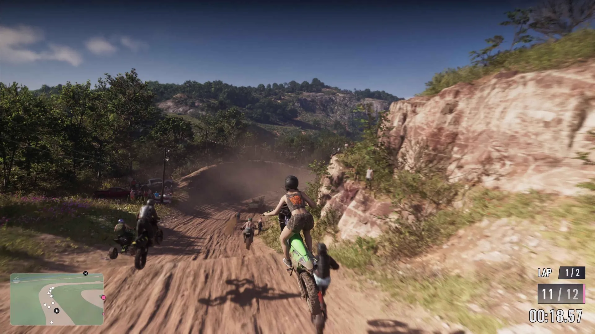 Dirt bikes racing up a rocky ridge trail through scrubland in the Mount Kalaga area of GTA 6