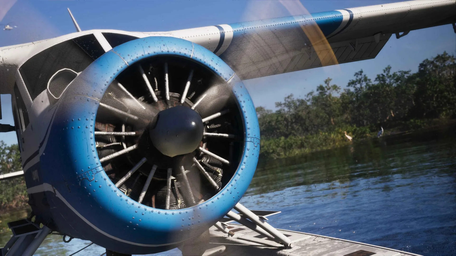 Close up of a seaplane’s blue radial engine cowling and spinning propeller on a river in GTA 6 with wading birds in the background.