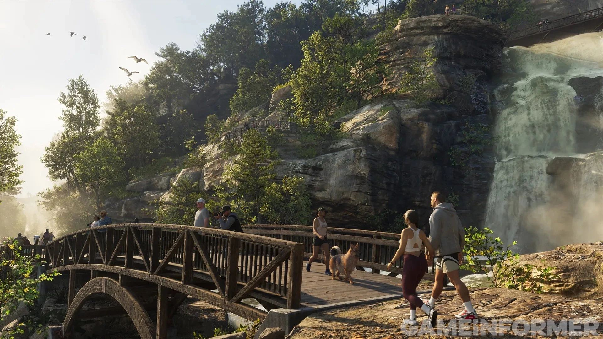 Hikers and a dog cross a wooden bridge over a waterfall in Mount Kalaga National Park in GTA 6