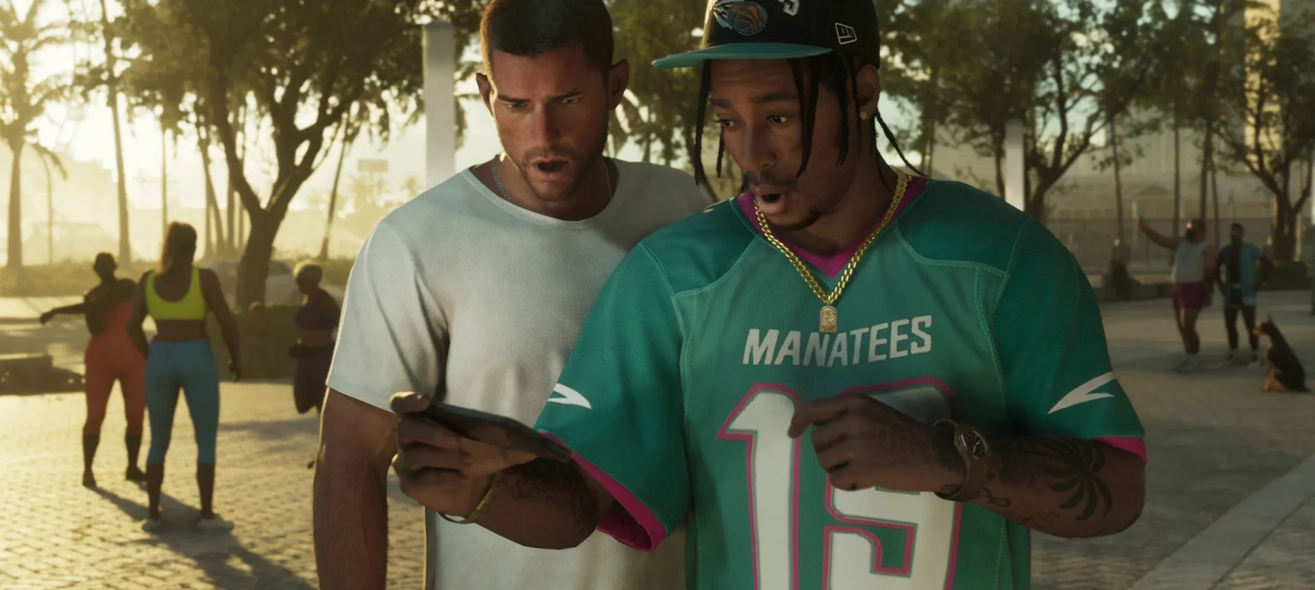 Two shocked men, one in a teal Manatees jersey, stare at a smartphone screen on a palm lined street in GTA 6.