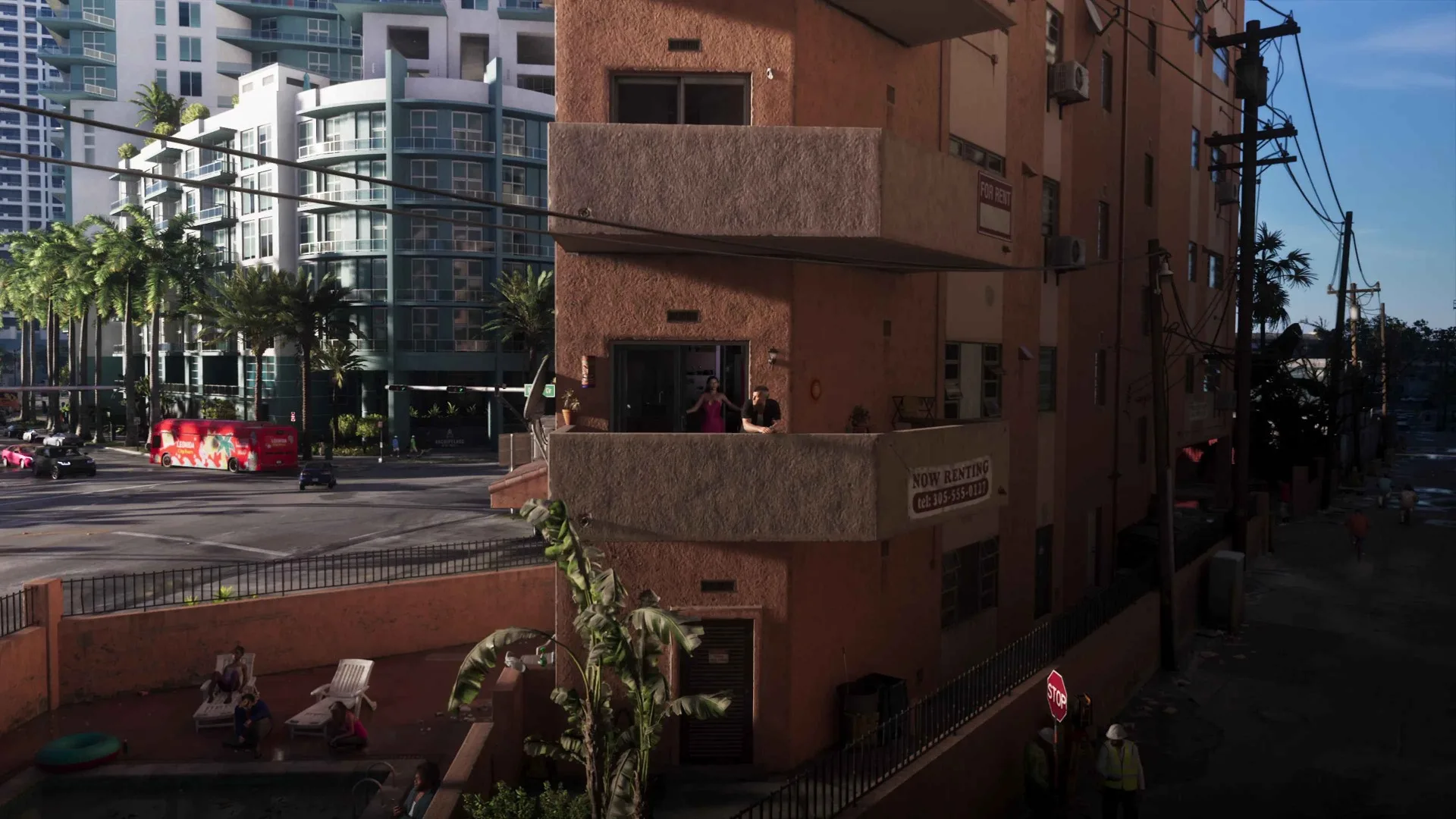 Jason and Lucia stand on the balcony of a coral coloured apartment block in GTA 6 with Now Renting and For Rent signs on the wall.