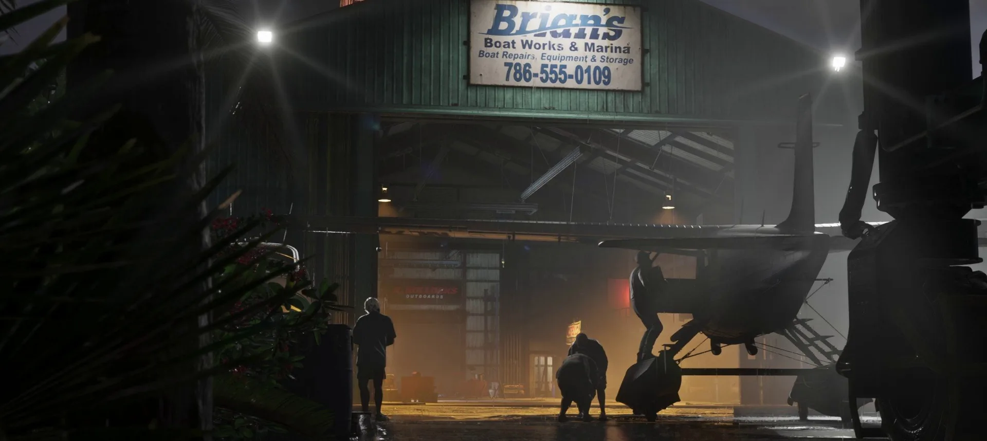 People work around a seaplane inside the Brian’s Boat Works and Marina hangar at night in GTA 6.