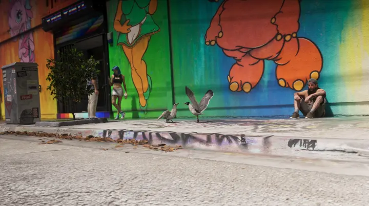Gulls strut past the rainbow mural