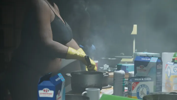 Yellow gloves over the steaming pot