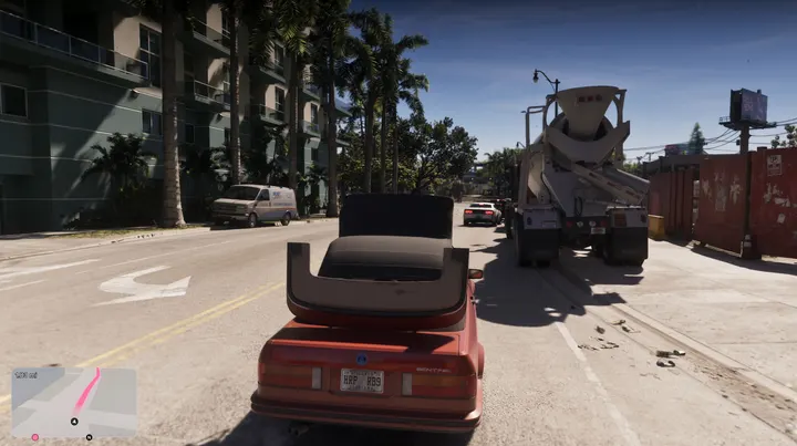 Red convertible behind the cement truck