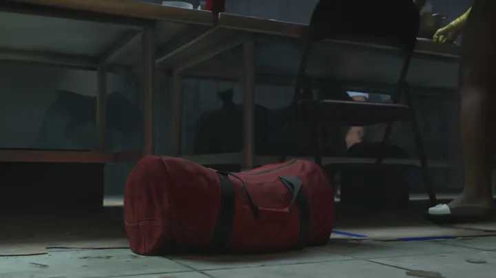 Red duffel under the table