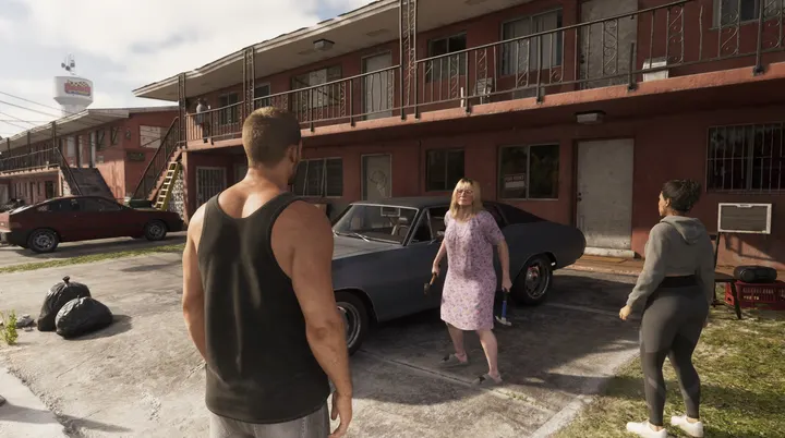 Courtyard chat by the muscle car