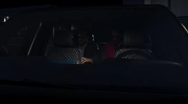 Two men in a darkened car