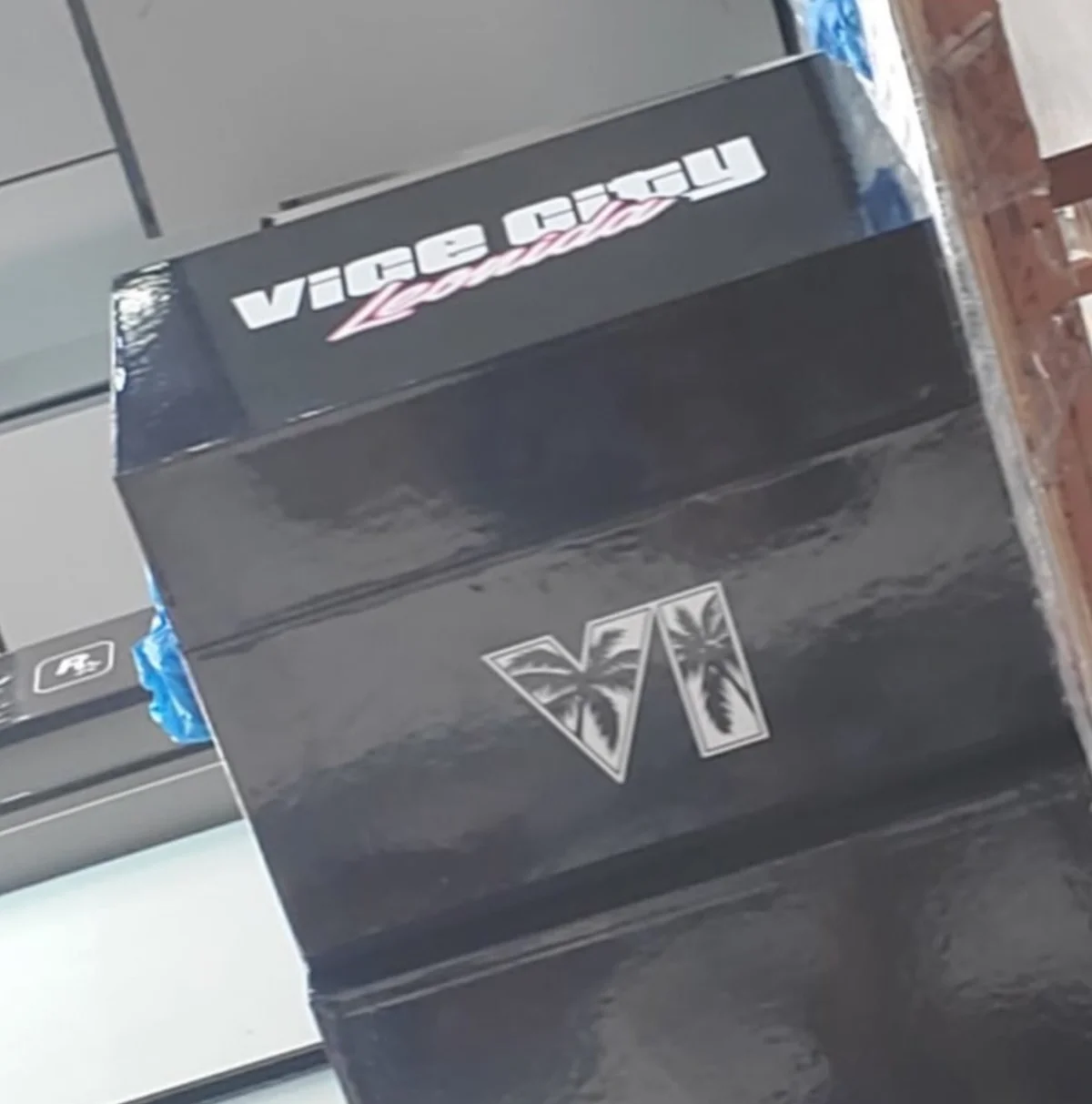 Leaked photo of a glossy black box with Vice City Leonida lettering on the lid and the GTA VI palm logo on the side
