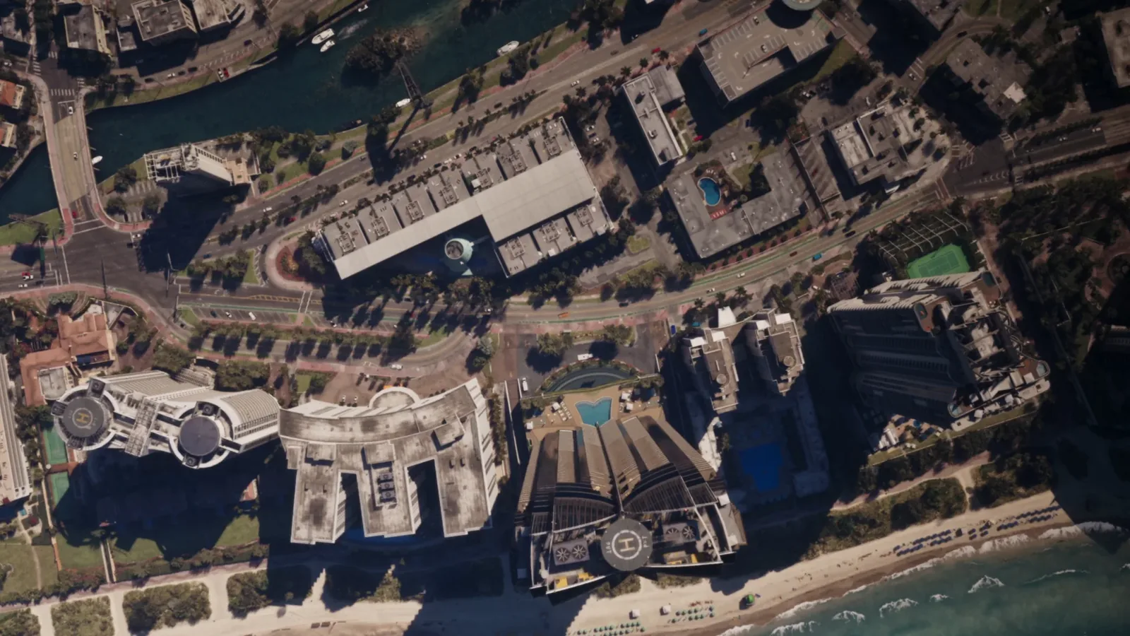 Top down aerial view of beachfront towers, pools and coastal roads in Vice City in GTA 6